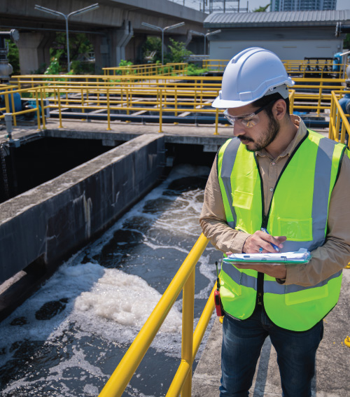 man inspecting water reclamation plant