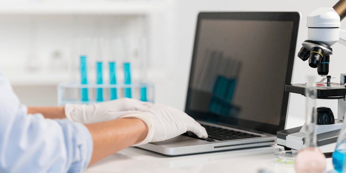 Woman working in laboratory close up on a laptop