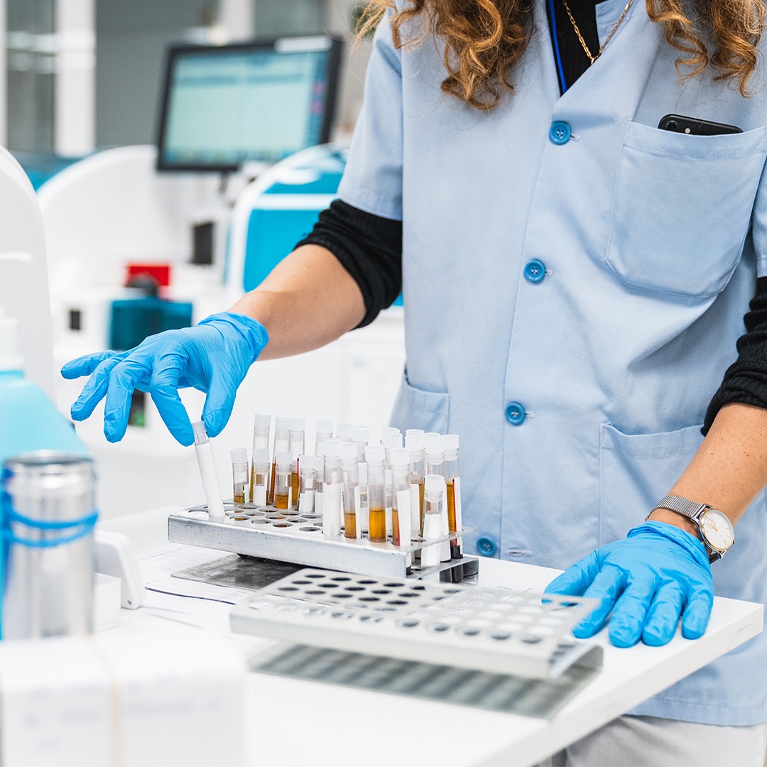 healthcare worker in lab coat processes blood tests