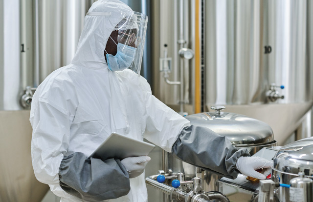 engineer in protective wear working on machinery