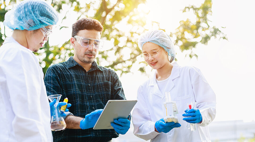Scientists analyzing data with tablet during outside field research