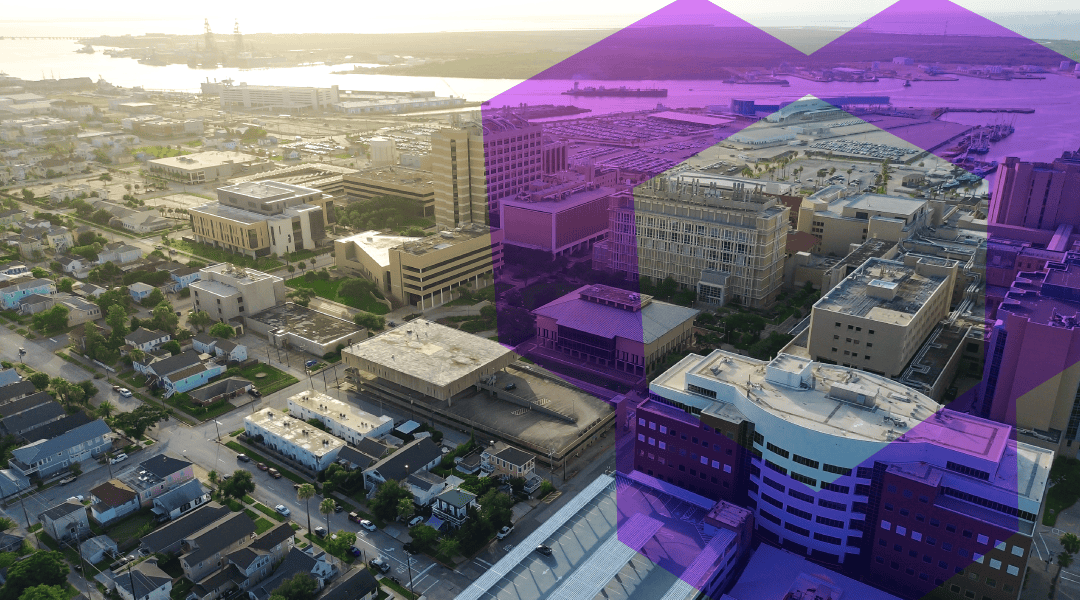 Aerial view of a coastal city with mix of houses and office buildings near a marina, bathed in golden light with purple geometric overlays nearby.
